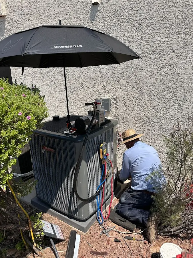 HVAC technician performing outdoor AC maintenance in Arden Hills